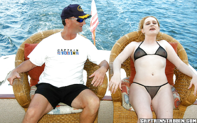 Redhead and a handsome captain having an affair in the sea