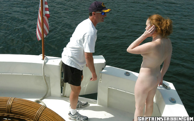 Redhead and a handsome captain having an affair in the sea